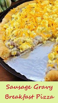 a sausage and gravy breakfast pizza on a pan with one slice taken out