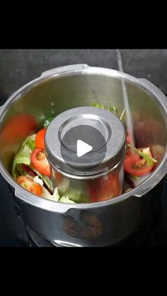 a pot filled with lots of vegetables on top of a stove