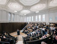 an auditorium full of people sitting in seats