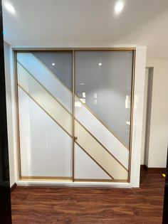 an empty room with sliding glass doors and hard wood flooring on the side wall