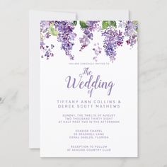 the wedding card features purple flowers and greenery