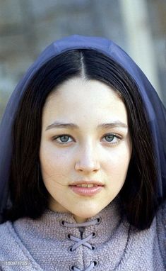 a young woman with dark hair and blue eyes