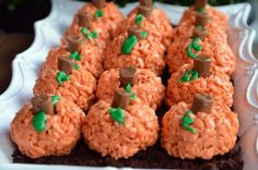 there are many treats made to look like pumpkins on the plate with green sprinkles