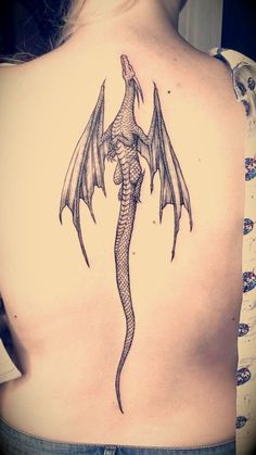 a woman with a dragon tattoo on her back