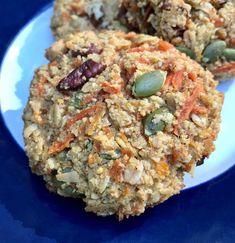 three cookies on a blue plate with nuts