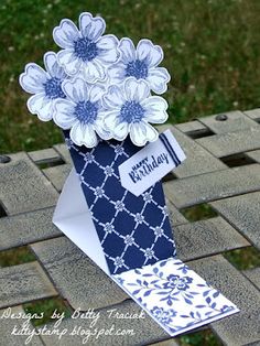 a blue and white vase with flowers in it