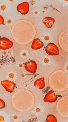 strawberries, lemons and daisies are arranged on a surface with water droplets