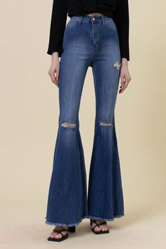 A pair of extreme flare jeans featuring a light distressed design, frayed raw hem, and ripped knee slits. These jeans offer two back patch pockets, faux front pockets, and a zip-fly closure. Rise: 11" Inseam: 34" Model is 5'11" and wearing a size 3 Miami Outfits