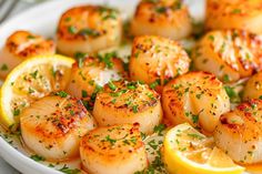 scallops with lemon and parsley on a white plate