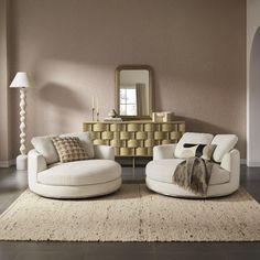 a living room with two white couches and a round chair in front of a mirror