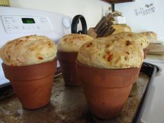 three potted breads sitting on top of a stove