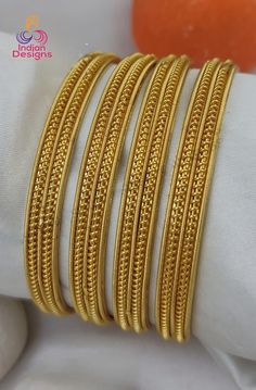 Elegant Set of Gold-Plated Bangles (Set of 4 ). Drawing inspiration from the rich tapestry of Indian jewelry and  features a unique combination of smooth and textured patterns, creating a mesmerizing effect that adds a touch of sophistication to any outfit. Perfect for weddings, festive occasions, or daily wear. Crafted with high-quality materials, they ensure durability and long-lasting shine. Adorn your wrists with these beautiful bangles and make a stunning impression wherever you go. Daily Wear Gold Bangles Indian, Daily Use Gold Bangles Indian, 4 Drawing, Beautiful Bangles, Gold Bangles Indian, Black Beads Mangalsutra, Gold Bangles For Women, Black Beads Mangalsutra Design, American Diamond Necklaces