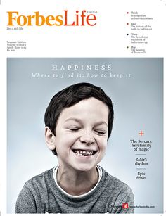 the front page of a magazine with a boy smiling and looking at something in his mouth