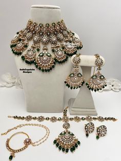 an assortment of green and white jewelry on display