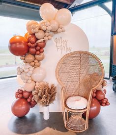 balloon arch with chair and balloons in front of it