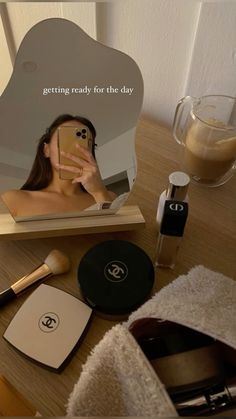 a woman taking a selfie with her cell phone in front of a mirror that says getting ready for the day