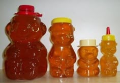 there are three plastic bears next to each other, one is orange and the other has yellow