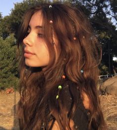 a woman with long hair and piercings on her head