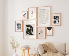 a living room filled with furniture and framed pictures on the wall above it's coffee table