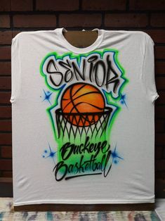 We create custom airbrush t shirts with your design. Personalize our air brush t shirts with your name and colors and we'll create a custom design just for you! 🔹 You can choose to have the design on the Front or Back of your item, and can add a name or short text to the opposite side for $10 more. We'll paint the additional name/text in a fitting style chosen by your artist. ⌚ Delivery Times typically Range from 1-2 weeks! If you need something be a specific date sooner than 2 weeks away, plea Airbrush T Shirts, Airbrush Designs, Sport Shirt Design, Custom Airbrushing, Basketball Design, Air Brush, Artist Style, Sports Theme, Sports Design