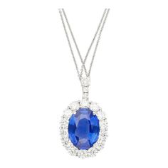 GRS Certified 5.83 Carat Oval Cut No Heat Sri Lanka Origin Blue Sapphire and Round Cut Diamond Halo Platinum Pendant Necklace.  Item Details: Item Type: Pendant Necklace Metal Type: Platinum 900 Weight 5.59 Grams Closure: Spring Ring   Center Stone Details: Type: Sri-Lanka Sapphire Carats: 5.83  Cut: Oval Setting: 4-Prong Certification: GRS  Side Stone Details: Type: Natural Diamonds Carat: 2.10 Total Cut: Round Quantity: 17 Setting: Prong Halo  This elegant platinum pendant necklace features a stunning 5.83 carat oval-cut no-heat Sri Lanka sapphire, certified by GRS, and set in a secure 4-prong design. Surrounded by a halo of 17 natural round-cut diamonds, totaling 2.10 carats, this piece radiates luxury and timeless beauty. Weighing 5.59 grams, this pendant is perfect for those who appre Oval Blue Diamond Necklaces, Blue Oval Diamond Necklaces, Blue Diamond Oval Pendant Necklace, Luxury Blue Oval Pendant Necklace, Formal Blue Oval Pendant Necklace, Pink Pendant Necklace, Purple Pendant Necklace, Platinum Pendant, Art Deco Pendant Necklace