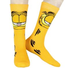 Celebrate Garfield's playful personality with these Garfield Comics Men's Novelty Garfield The Cat Big Face Character Orange Rib Knit Crew Socks. Featuring a bold design of the lasagna-loving cat, these vibrant socks display Garfield's fur stripes running down the sides. The fuzzy-textured cheeks add a fun, tactile detail to the look. Rib-knit cuffs keep the socks securely in place, preventing slipping or bunching as you show off your Garfield fandom. Perfect for any occasion, they bring a whims Socks Display, Sock Display, Garfield The Cat, Socks Party, Garfield Comics, Face Funny, Ankle Socks Women, Mens Crew Socks, Face Characters