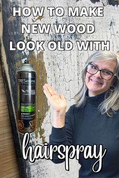 a woman in black shirt and glasses standing next to a sign that says how to make new wood look old with hairspray