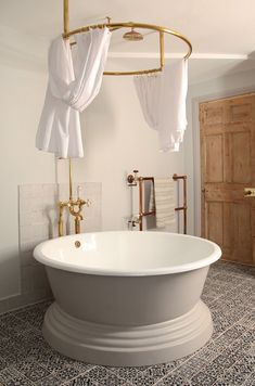 a white bath tub sitting inside of a bathroom