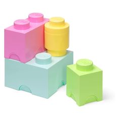 three lego blocks are stacked on top of each other, one is yellow and the other is pink