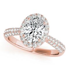 a rose gold engagement ring with an oval cut diamond in the center