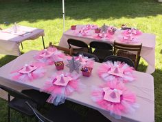 a table set up with pink and silver decorations