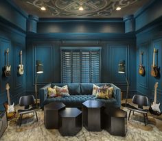 a living room filled with furniture and guitars