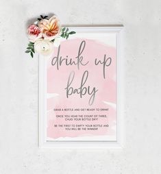 a pink watercolor baby shower sign with flowers on the side and text that reads, drink up baby