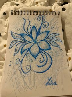 a drawing of a blue flower on top of a sheet of paper with polka dots