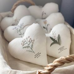 some white heart shaped pillows in a basket