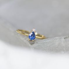 A 14K gold ring with a natural sapphire gemstone pear cut and a diamond brilliant cut in white gold or in yellow gold. A perfect engagement gold ring for women, stacking and delicate that adds glam to every outfit. Sapphire is the birthstone of September. 100% handcrafted with love! D E T A I L S ● Metal: 14K solid white gold, 14K gold, 14K rose gold ● Gemstones: Sapphire, Diamond ● Gemstones weight: Sapphire 0.4ct, Diamond 0.02ct ● Sapphire dimensions: 5.4 x 4.2 mm R I N G ∙ S I Z I N G For Gen Fine Jewelry Pear-shaped Sapphire Ring, Pear-shaped Birthstone Promise Ring, Pear-shaped Sapphire Ring, Fine Jewelry Sapphire Ring With Pear Shape, Yellow Gold Teardrop Sapphire Ring Fine Jewelry, Teardrop Sapphire Ring In Yellow Gold, Teardrop Yellow Gold Sapphire Ring, Pear-shaped Sapphire Gemstone Rings, Pear-shaped Sapphire Diamond Ring