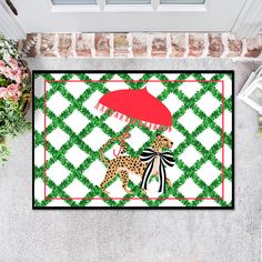 a welcome mat with two giraffes holding an umbrella