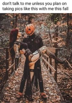 two people dressed up in halloween costumes standing on a bridge with pumpkins and leaves all around them