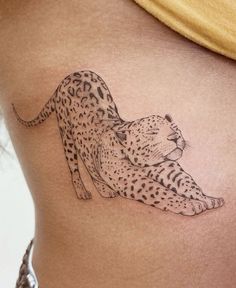 a woman's stomach with a tattoo of a cheetah