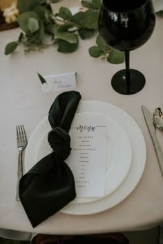 the place setting is set with black napkins and silverware