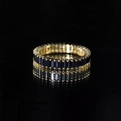 Product Details Stylish stackable eternity ring with baguette-cut black onyx. Perfect for adding an elegant touch to any outfit. Product Information SKU SHP-RINGS032218643 Width 1.4 mm Height 2.5 mm Weight 2.16 gm (Approximate) BLACK ONYX INFORMATION No.of Stones 45 Pieces Total Weight 2.70 Carat (Approximate) Dimension(approx) Baguette-1.50X3.00 mm-45 Pcs Color Black Cut Brilliant Shape Baguette Setting Type Shared-Prong-Setting Quality Grade AAA View More Product Parent Collection Handle black Eternity Rings Stackable, Full Eternity Ring, 18k Yellow Gold Ring, Baguette Cut, Black Rings, Yellow Gold Rings, Eternity Ring, Black Onyx, Prong Setting