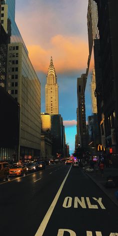 a city street with tall buildings in the background