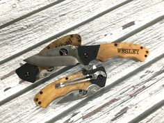 three different types of knives sitting on top of a wooden table