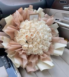 a bouquet of white roses in the center of a car