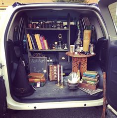 the back end of a van filled with books and other items