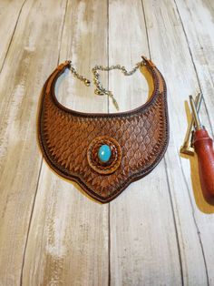 -24x18x9mm Sleeping Beauty Turquoise Cabochon  -Hand Tooled 7/8oz Leather  -Saddle tan and Briar brown finished  -Stainless steel chain for lengthening  -15 inch from leather to leather end -Can fit up to 23 inch without chain to show. -Can be worn outside shirt or around neck giving you a style all your own. Feel free to message me of my coupon codes, I also have bundle and save coupons. Handmade Adjustable Brown Turquoise Necklace, Artisan Brown Turquoise Necklace For Jewelry Making, Artisan Brown Jewelry With Concho Details, Artisan Brown Jewelry With Concho, Artisan Brown Concho Jewelry, Rustic Brown Jewelry For Ranch, Western Brown Hand-tooled Jewelry, Artisan Handcrafted Brown Jewelry, Western Style Brown Jewelry For Western-themed Events