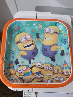 an orange and blue tray with two minion characters on it