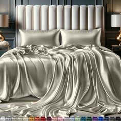 an image of a bed with satin sheets and pillows in the room that is decorated