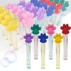 a bunch of different colored mickey mouse shaped items in glass tubes with bubbles on the side