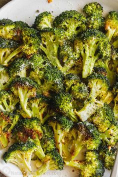 broccoli florets in a white bowl on a table